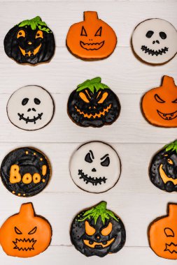 top view of homemade and tasty halloween cookies on white surface  clipart