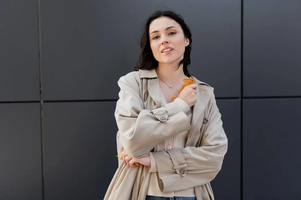 Mujer Joven Impermeable Otoño Sosteniendo Hojas Amarillas Mientras Mira Cámara — Foto de Stock