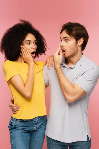 Amazed Hispanic Woman Looking Boyfriend Grimacing While Touching Nose Isolated — Stock Photo, Image