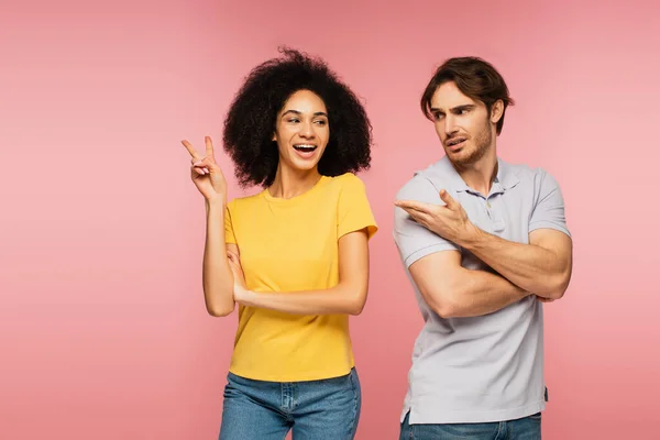 Upset Man Pointing Excited Hispanic Woman Showing Victory Gesture Isolated — Stock Photo, Image