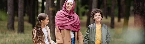 Cheerful Muslim Boy Walking Mother Sister Park Banner — Stock Photo, Image