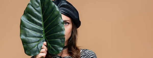 Young Woman Leather Beret Holding Green Leaf While Covering Face — Stock Photo, Image