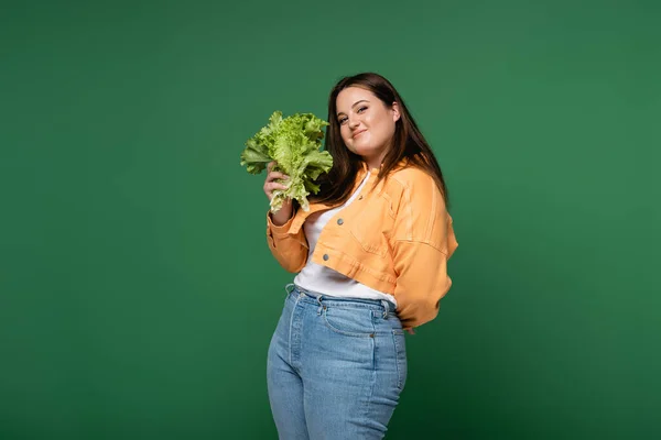 年轻的体形呈阳性的女子 手持用绿色隔离的新鲜生菜 — 图库照片