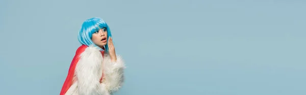 Astonished Asian Woman Wig Furry Jacket Looking Away Isolated Blue — Stock Photo, Image