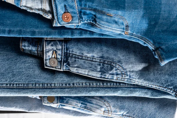 Stack of different blue jeans, close up view — Stock Photo