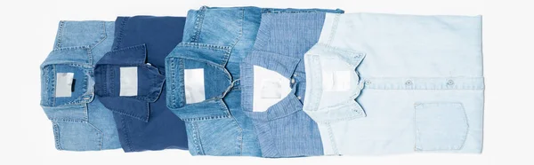 Flat lay of different blue denim shirts on white, top view, banner — Stock Photo