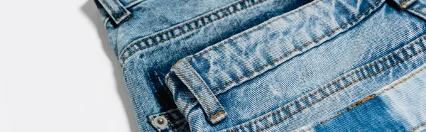 Close up view of pair of blue jeans on white background, banner — Stock Photo