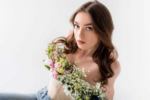 High angle view of young woman with flowers in blouse looking at camera isolated on grey — Stock Photo