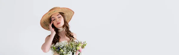 Woman in straw hat standing with closed eyes near flowers isolated on grey, banner — Stock Photo