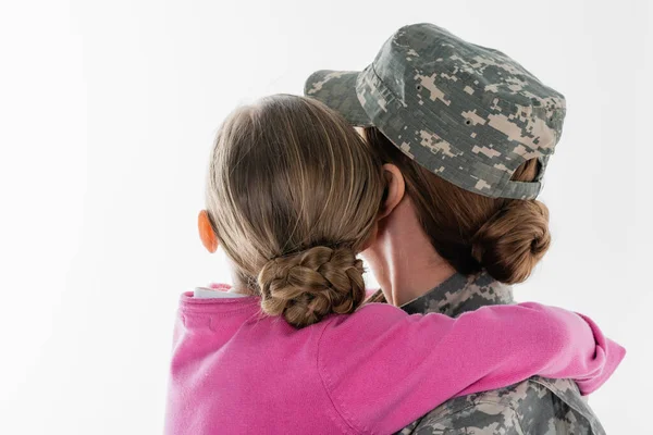 Back view of kid hugging soldier isolated on white — Stock Photo