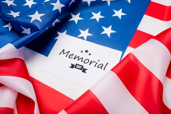 Card with memorial day lettering on american flag — Stock Photo