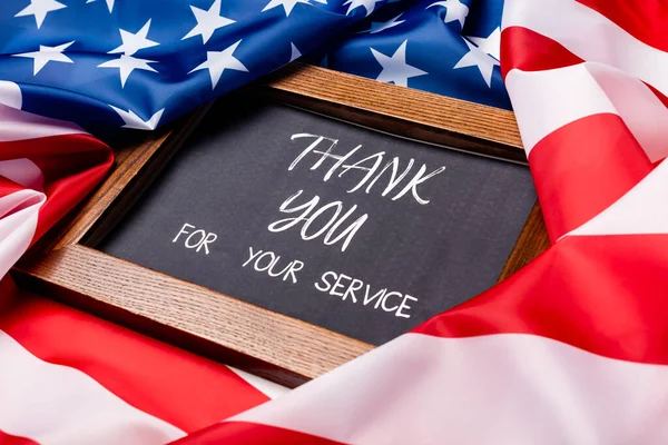 Chalkboard with thank you for your service lettering on american flag — Stock Photo