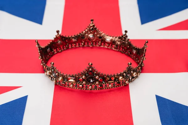 Golden royal crown on british flag — Stock Photo