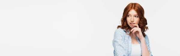 Pensive redhead young woman in blue checkered shirt looking away isolated on white, banner — Stock Photo