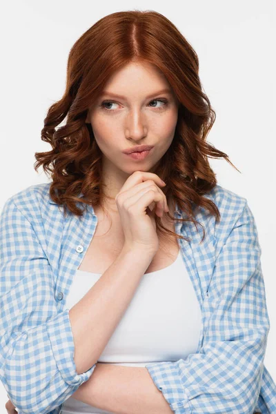 Pensive redhead woman in blue shirt looking away isolated on white — Stock Photo