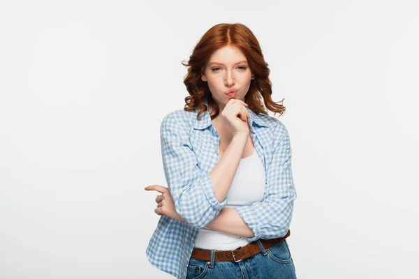 Thoughtful redhead woman in checkered shirt isolated on white — Stock Photo