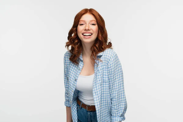 Fröhliche rothaarige Frau in kariertem Hemd isoliert auf weiß — Stockfoto