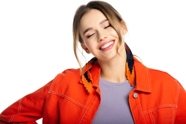 Happy young woman with closed eyes in orange shirt isolated on white — Stock Photo