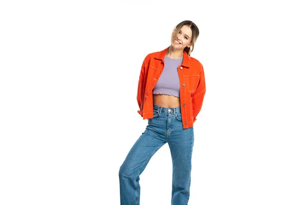 Happy young woman in jeans, crop top and orange shirt isolated on white — Stock Photo