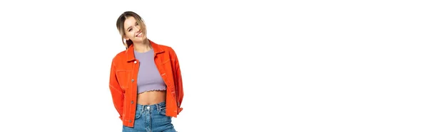Glückliche junge Frau in Jeans, bauchfreiem Oberteil und orangefarbenem Hemd posiert isoliert auf weißem Banner — Stockfoto