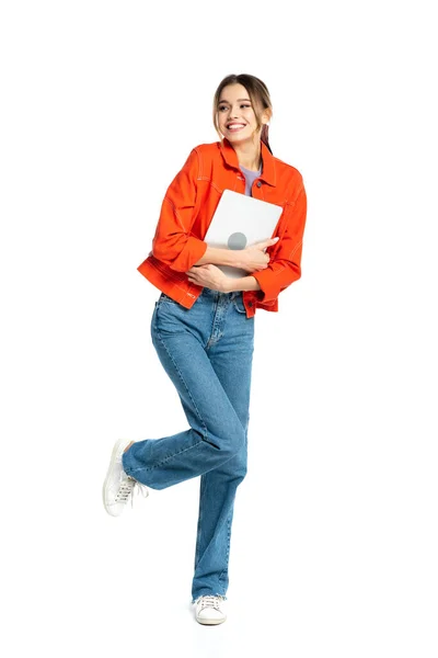 Full length of cheerful woman holding laptop isolated on white — Stock Photo