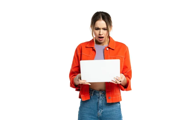 Shocked young woman holding laptop isolated on white — Stock Photo