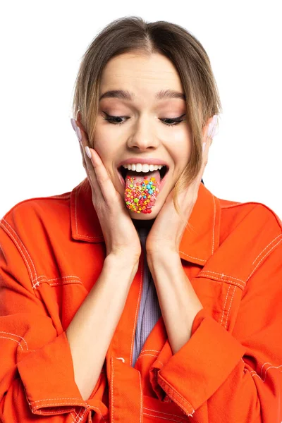 Young woman sticking out tongue with tasty sprinkles isolated on white — Stock Photo