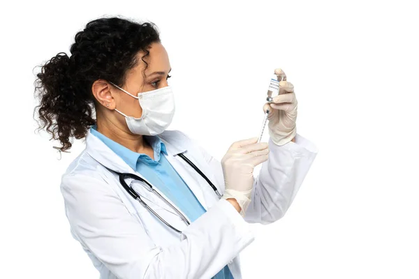 African american doctor in medical mask picking up vaccine isolated on white — Stock Photo
