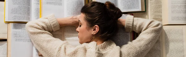 Top view of tired woman sleeping near open books, banner — Stock Photo