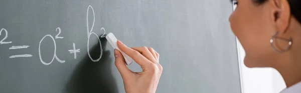 Vista ritagliata di insegnante offuscata scrittura equazione matematica, banner — Foto stock