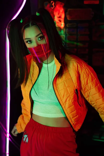 Trendy young asian woman in red face shield looking at camera — Stock Photo