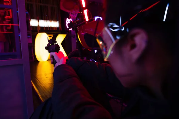 Blurred asian woman aiming with gun outside — Stock Photo