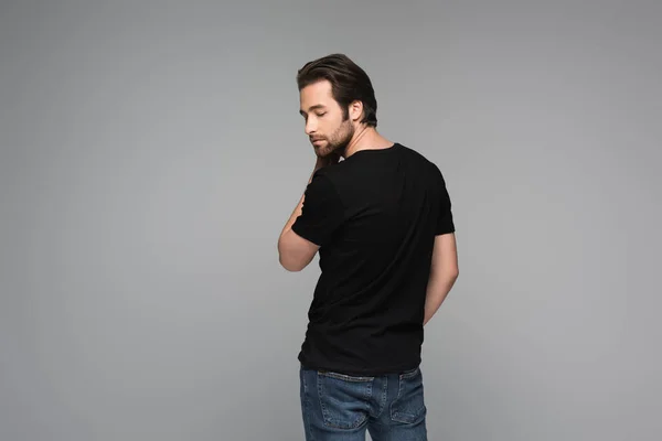 Bearded man in black t-shirt posing isolated on grey — Stock Photo