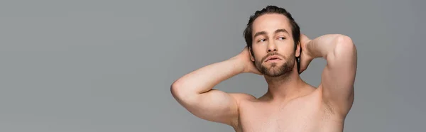 Shirtless man posing while looking away isolated on grey, banner — Stock Photo