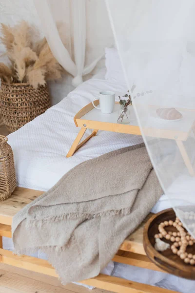 High angle view of table with breakfast on bed with white linen in bohemian style bedroom — Stock Photo