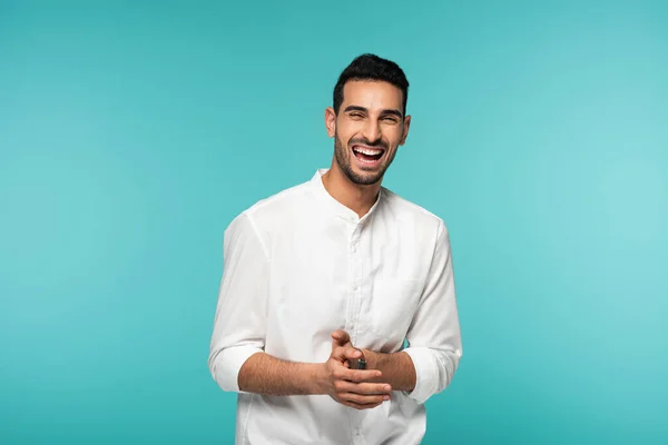 Cheerful arabian man looking at camera isolated on blue — Stock Photo