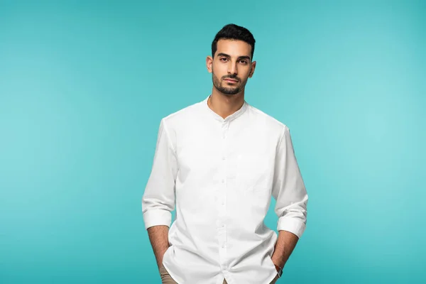 Muslim man in white shirt looking at camera isolated on blue — Stock Photo