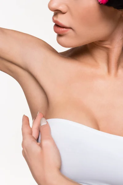 Partial view of young woman touching smooth armpit with hand isolated on white — Stock Photo