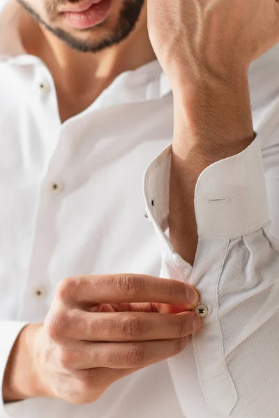 Vista recortada del hombre borroso con manga de camisa blanca - foto de stock