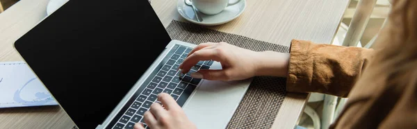 Vista ritagliata di freelance utilizzando laptop vicino al menu e tazza in caffè, banner — Foto stock