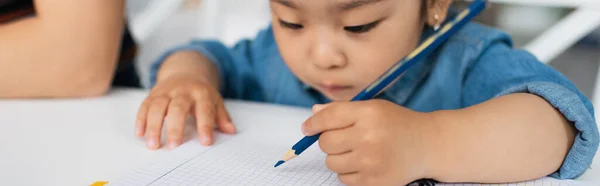 Blurred asian girl drawing on notebook, banner — Stock Photo