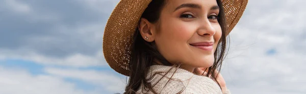 Pleased young woman in sun hat against blue sky, banner — Stock Photo