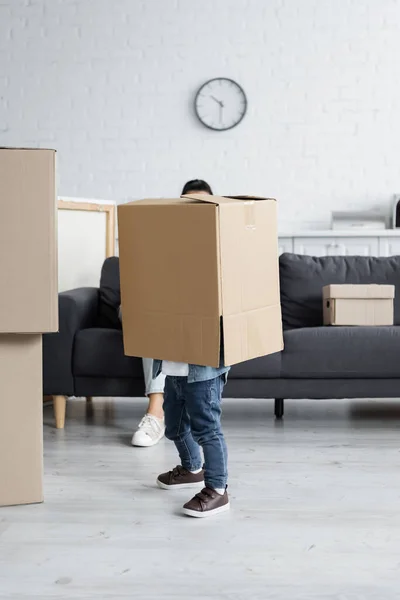 Man obscuring face while standing in carton box — Stock Photo