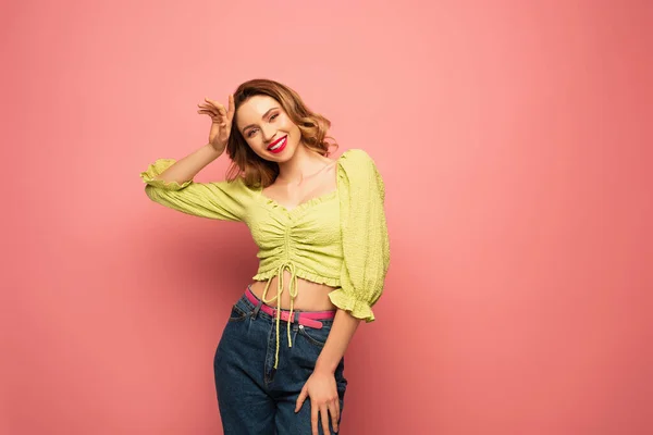 Smiling woman in green blouse posing isolated on pink — Stock Photo