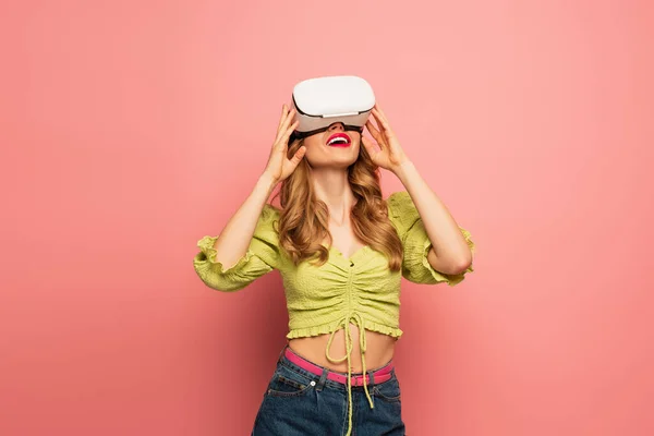 Amazed woman in vr headset isolated on pink — Stock Photo