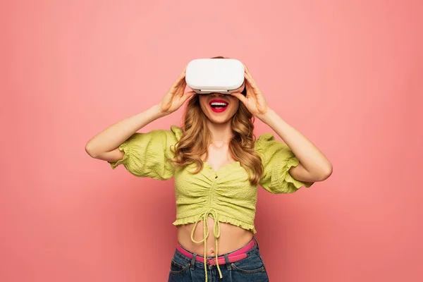 Positive woman in vr headset isolated on pink — Stock Photo
