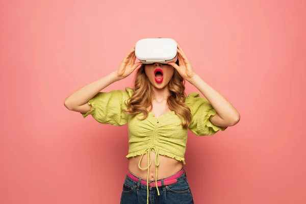 Shocked woman in vr headset isolated on pink — Stock Photo