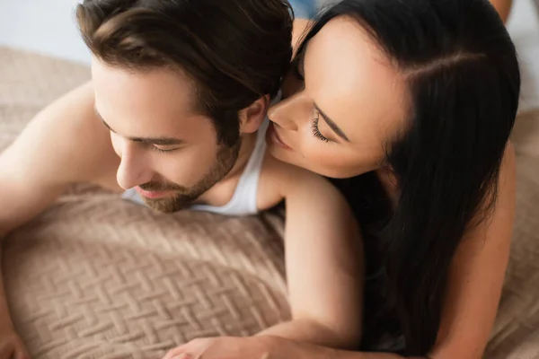 High angle view of young couple lying in bed — Stock Photo