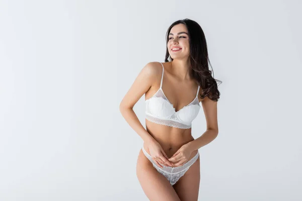 Joyful young woman in lace underwear posing isolated on white — Stock Photo