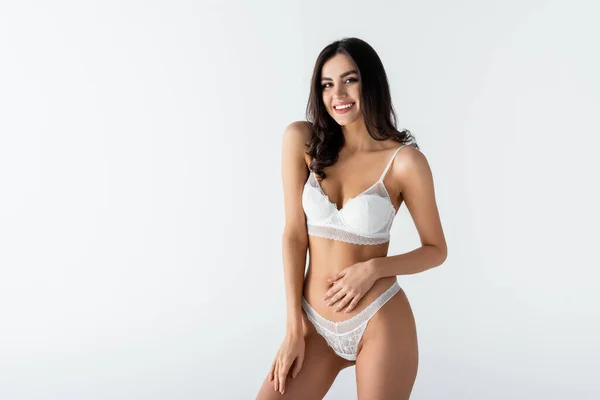 Positivo giovane donna in lingerie posa isolata su bianco — Foto stock